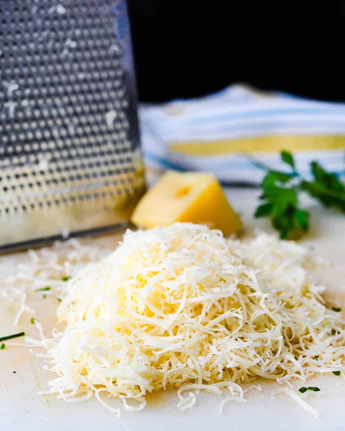 Grating cheese on a box grater. 