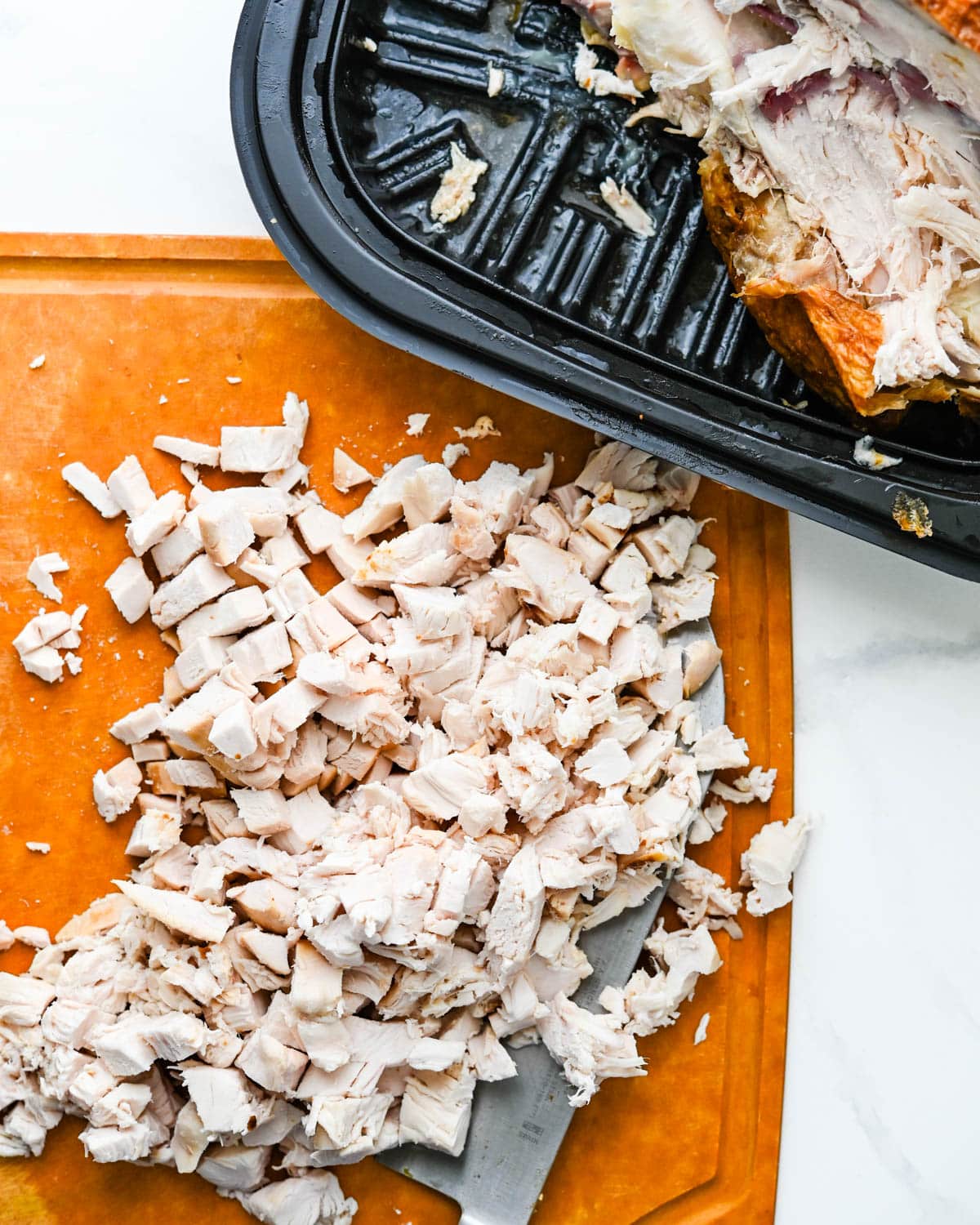 Dicing meat from the rotisserie chicken.