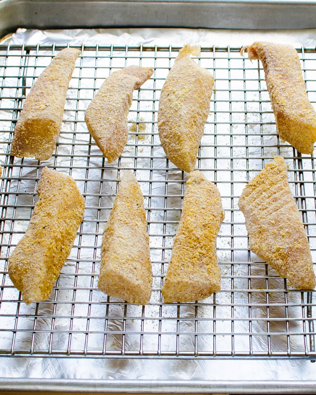 Baking the cornmeal crusted fish on a wire rack.