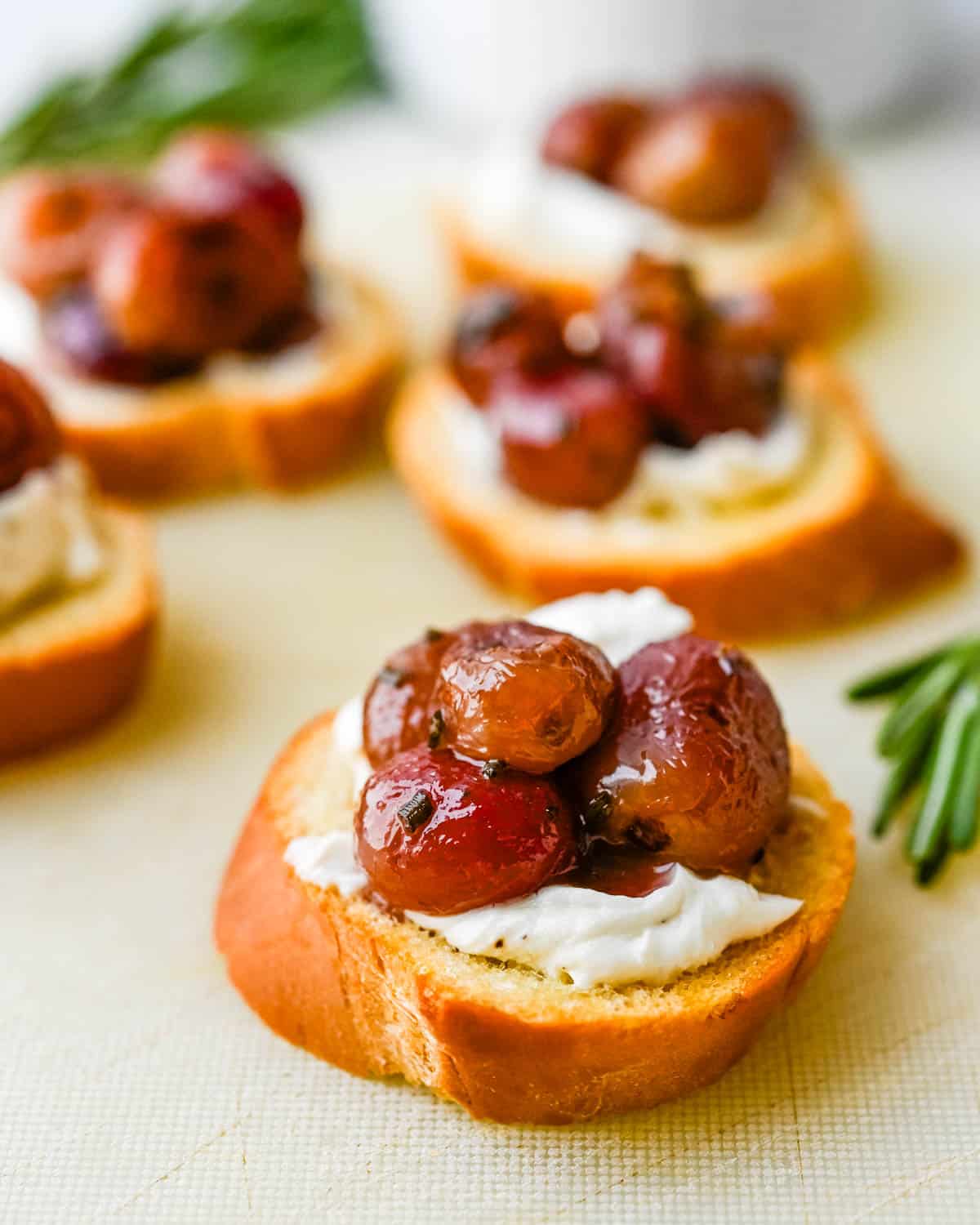 Top each crostini with goat cheese and a spoonful of the rosemary roasted grapes. 