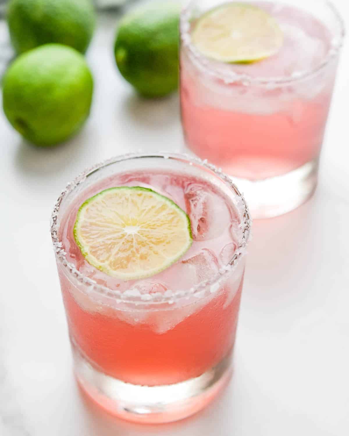 Floating a lime in the hibiscus margarita to serve.