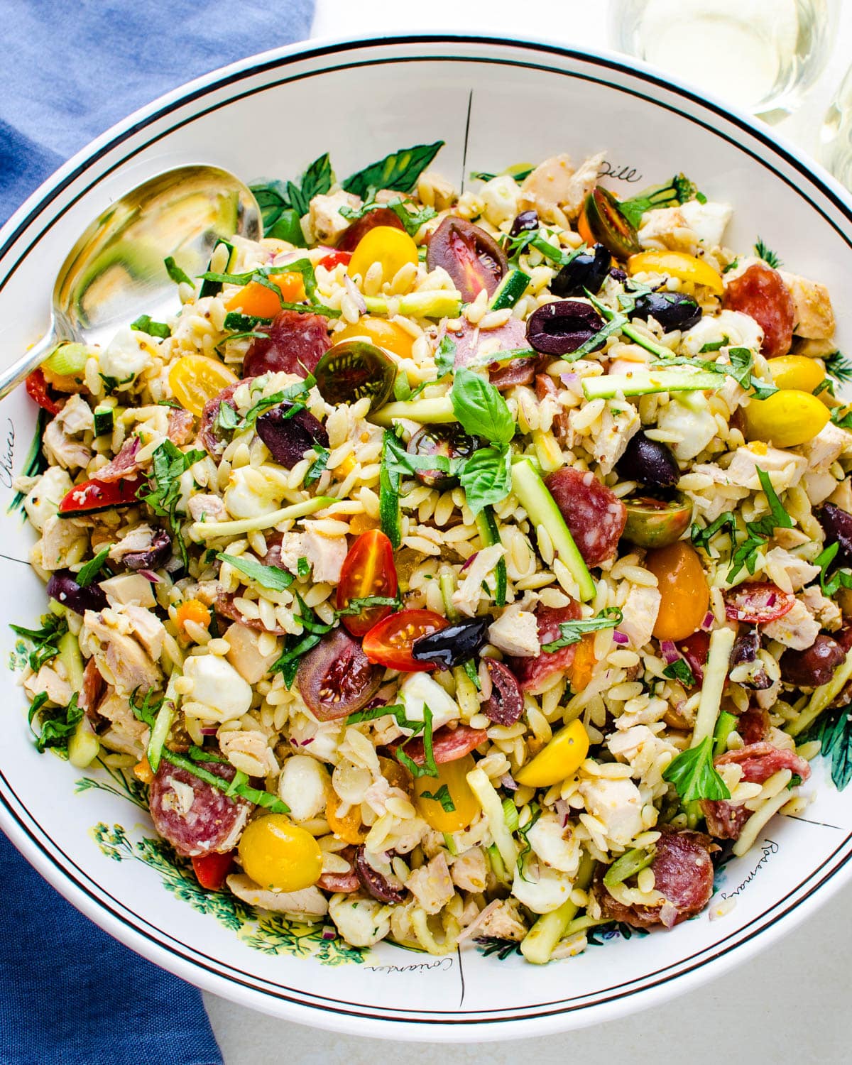 The chicken salad with orzo and vegetables in a large serving bowl. 