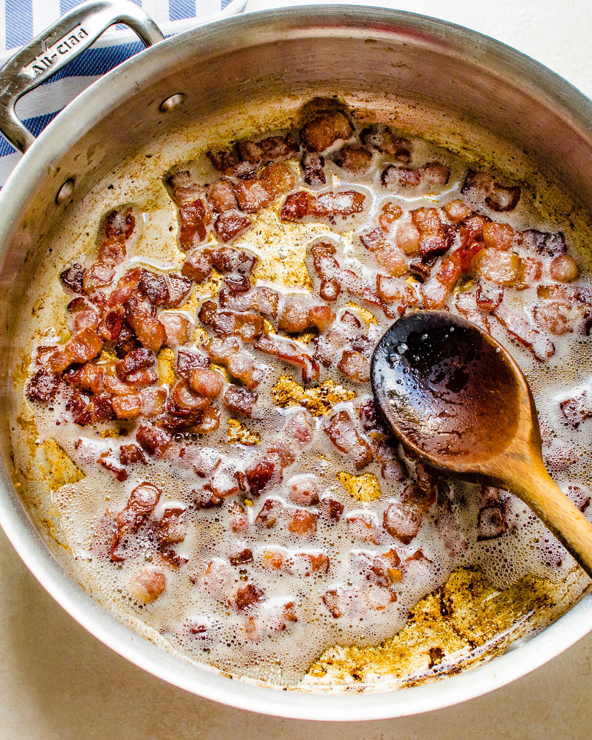 Crisping bacon in a skillet.