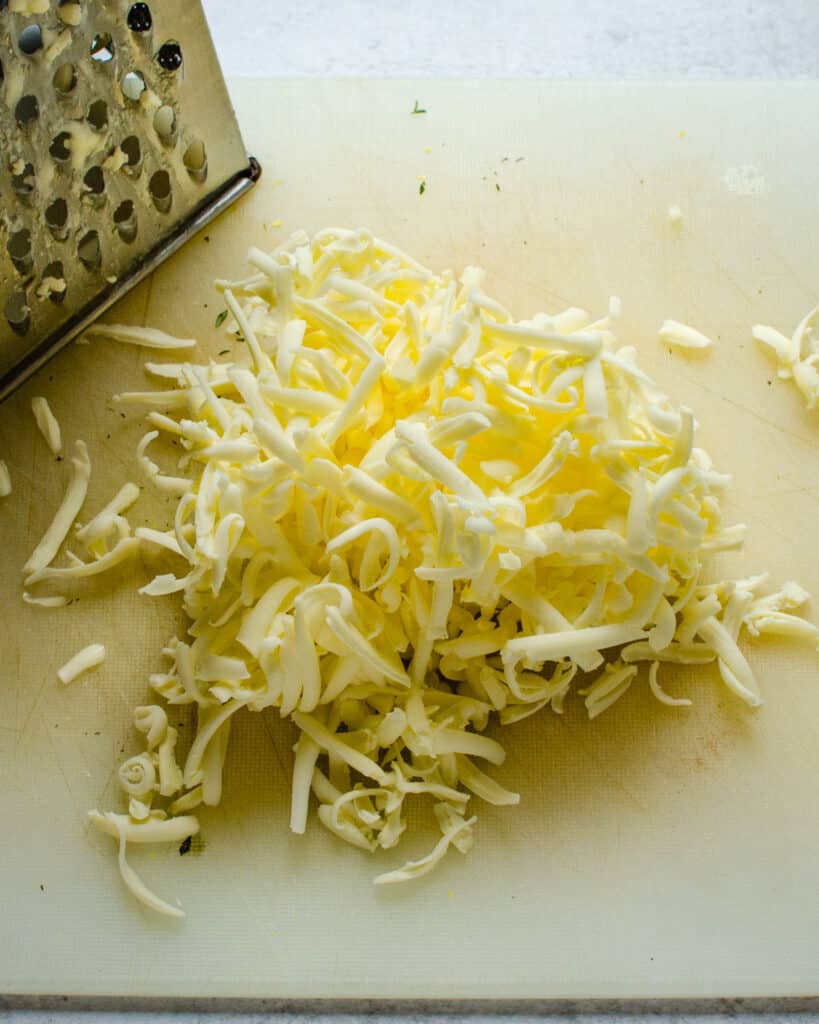 Grating frozen butter for the crisp topping.