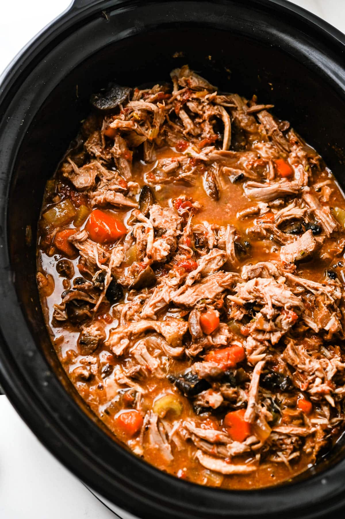a Slow cooker filled with pork ragu.