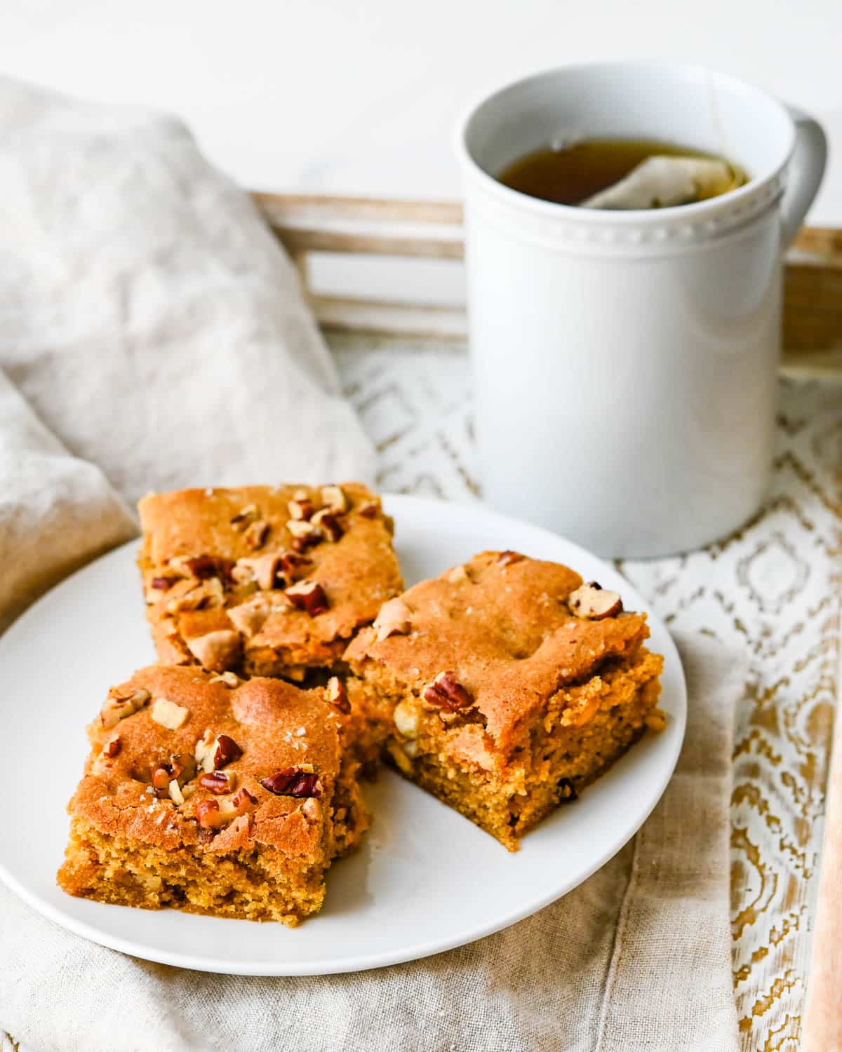 Serving pumpkin blondies with a cup of tea.