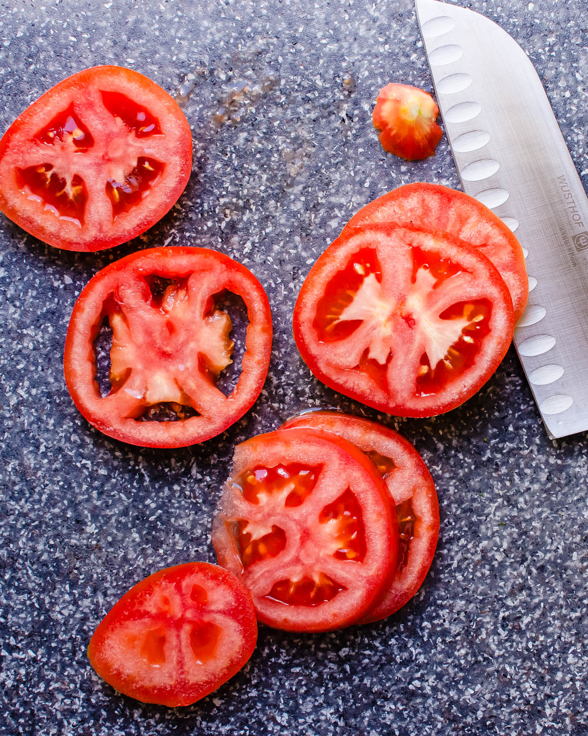 Slicing tomatoes and removing the seeds.