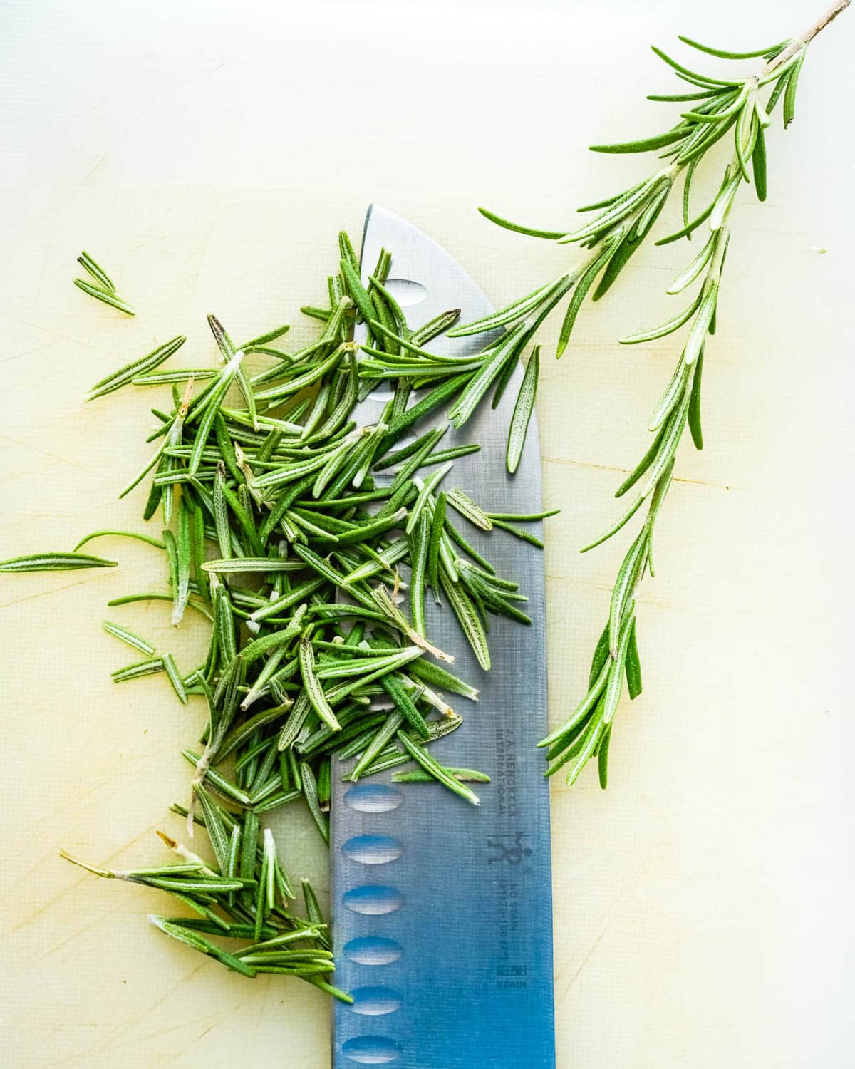 Chopping fresh rosemary for the cookies.