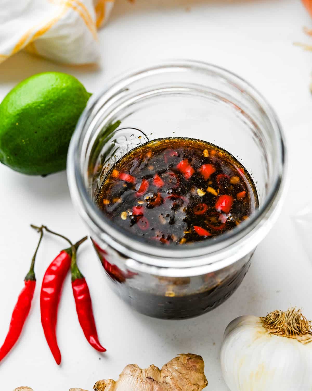 A jar of Asian chicken marinade with red chilies.