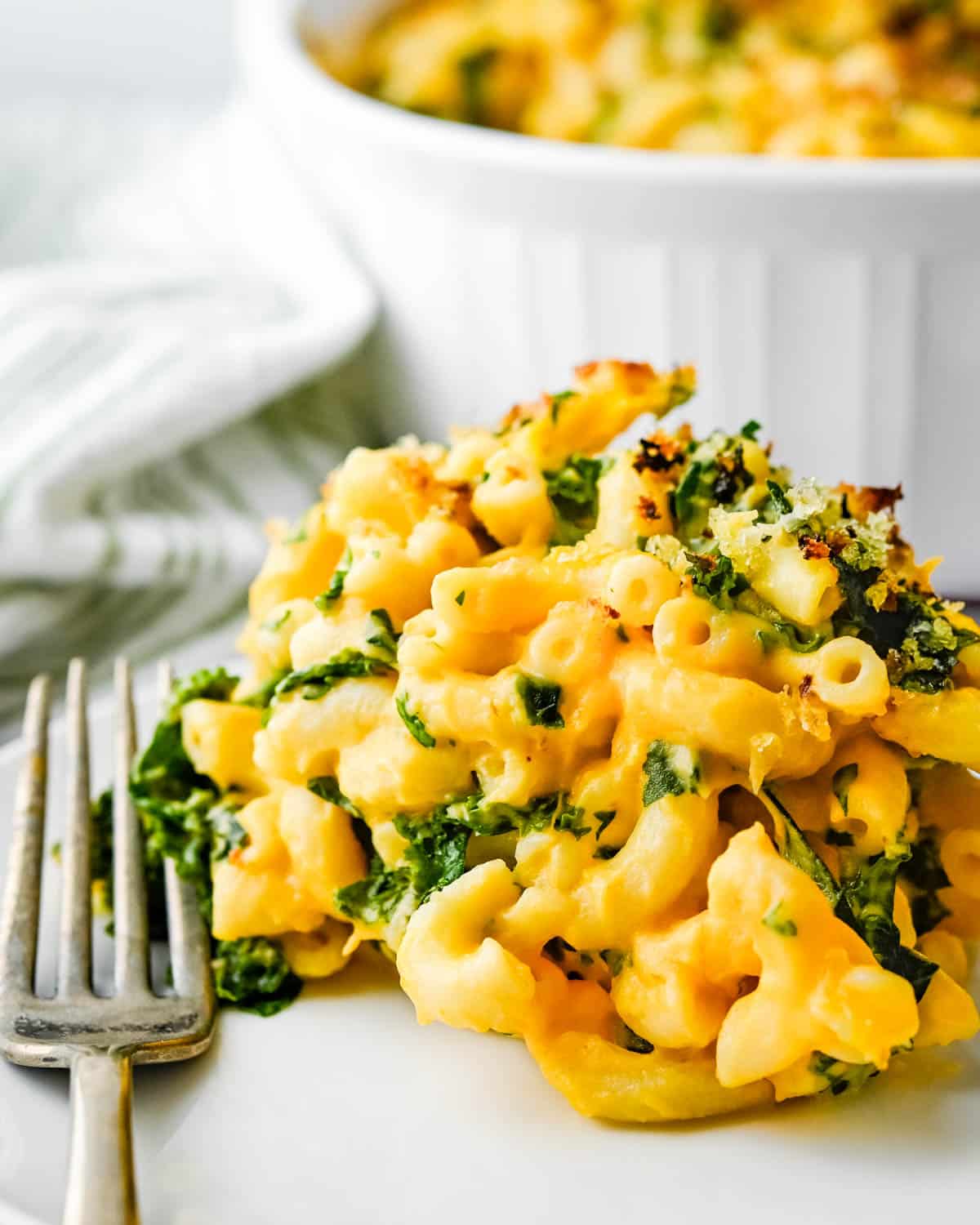 Serving the healthy butternut squash mac and cheese on a plate.