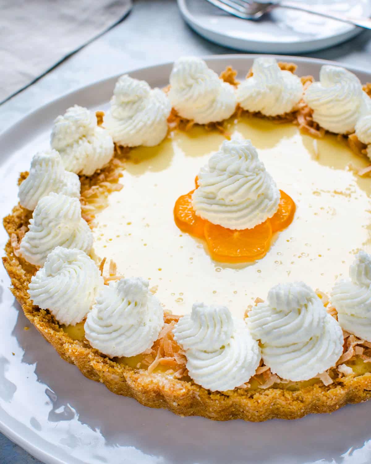A calamondin pie with graham cracker crust and whipped cream.