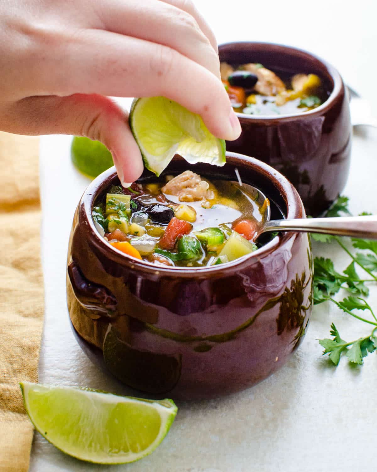 Squeezing fresh lime into the soup.