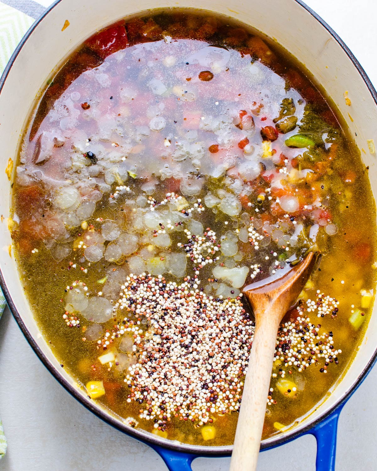 Adding the quinoa to the soup.