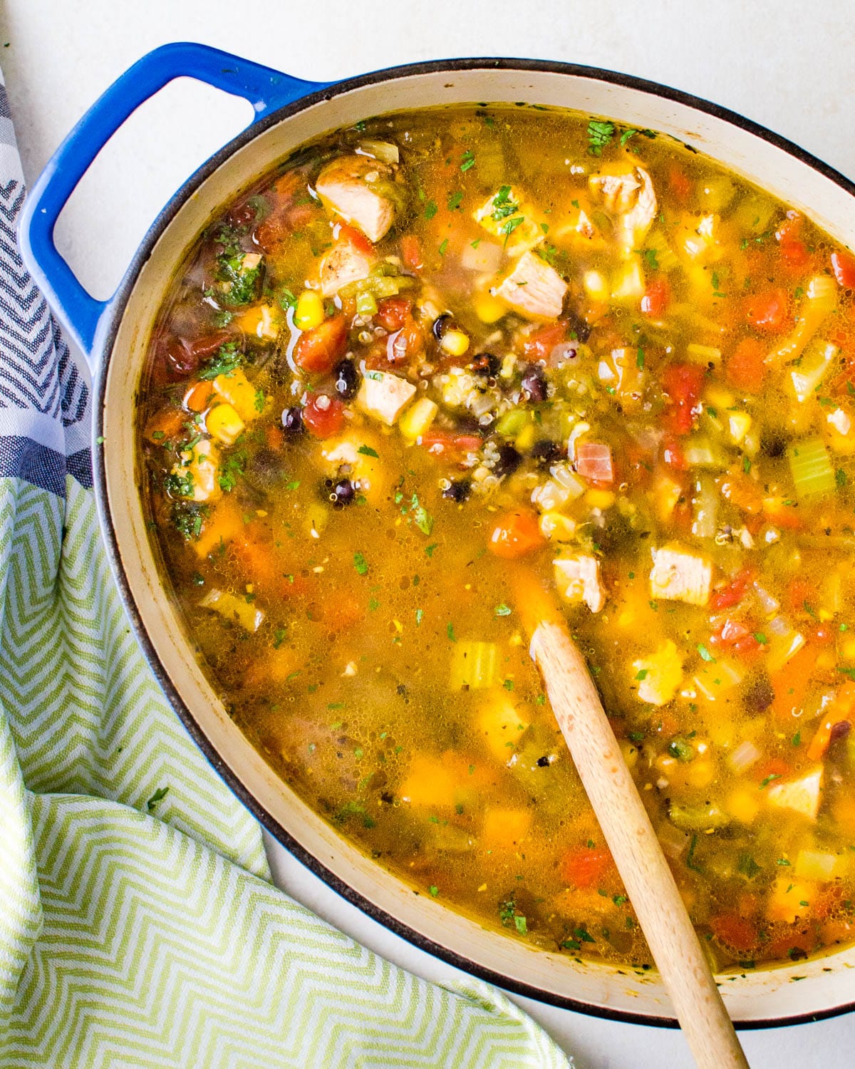 A pot of Chicken Quinoa soup with black beans, corn and tomatoes. 