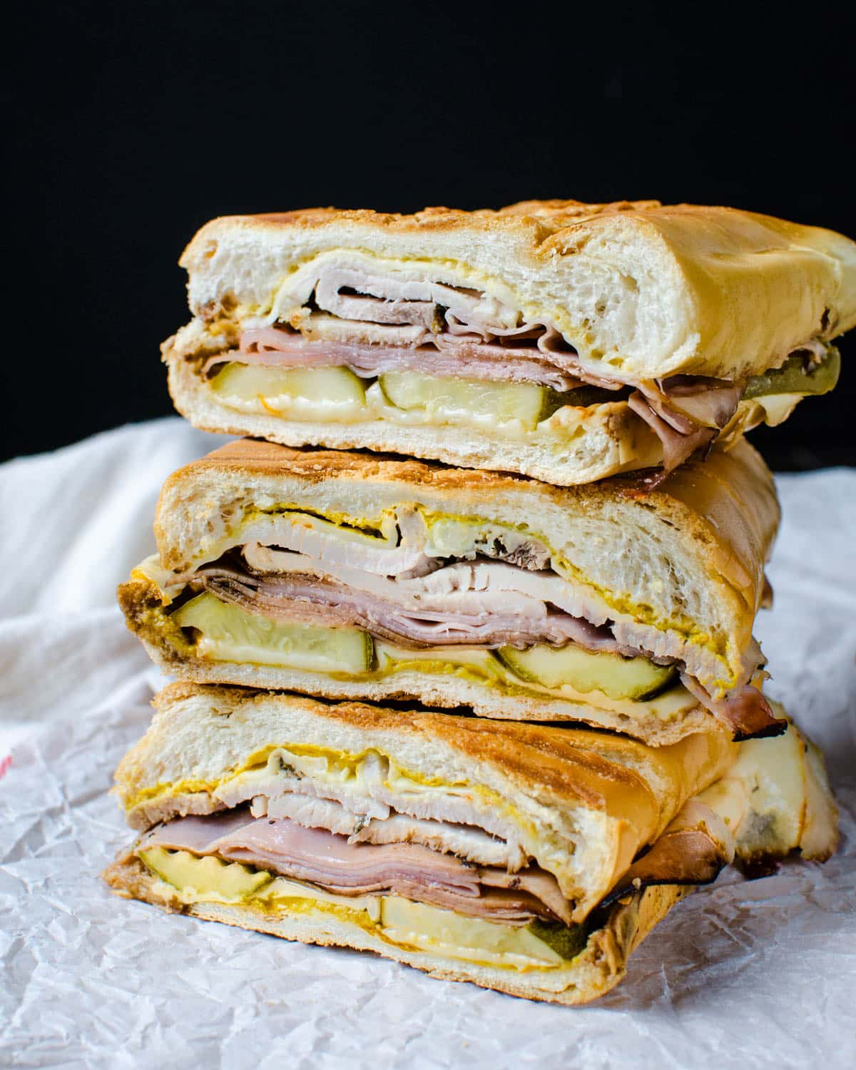 A stack of Cuban Sandwiches. 