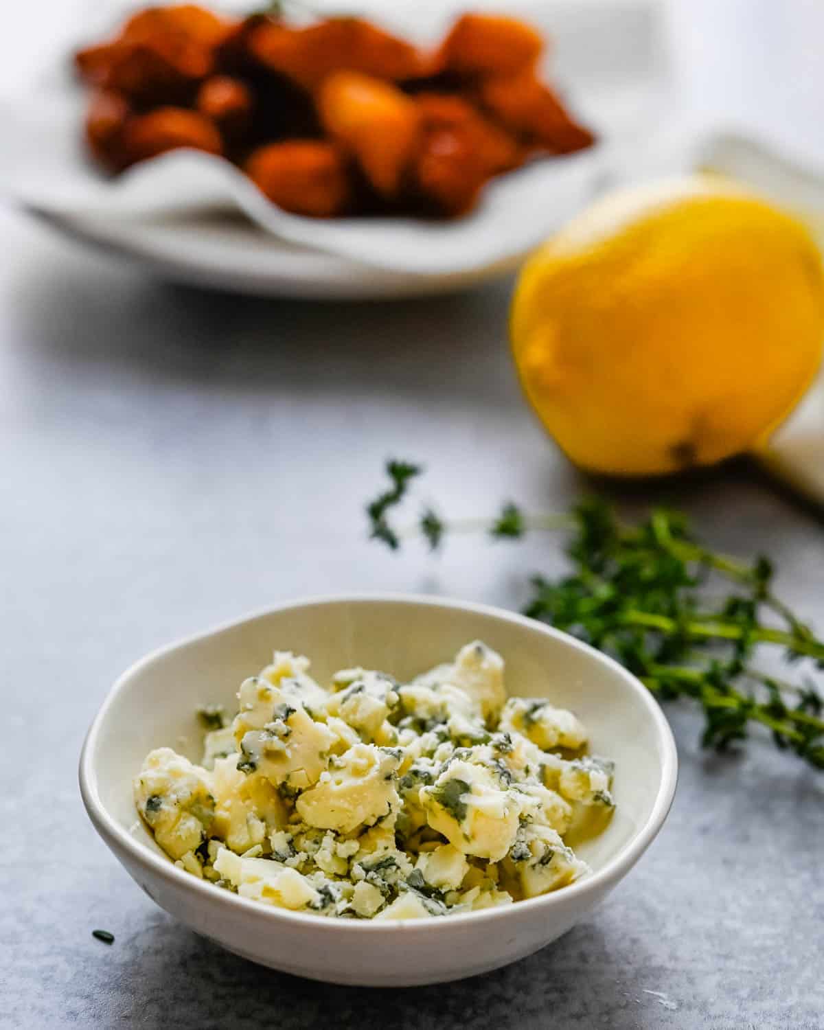 crumbled blue cheese, thyme and lemon to garnish the fried gnocchi.