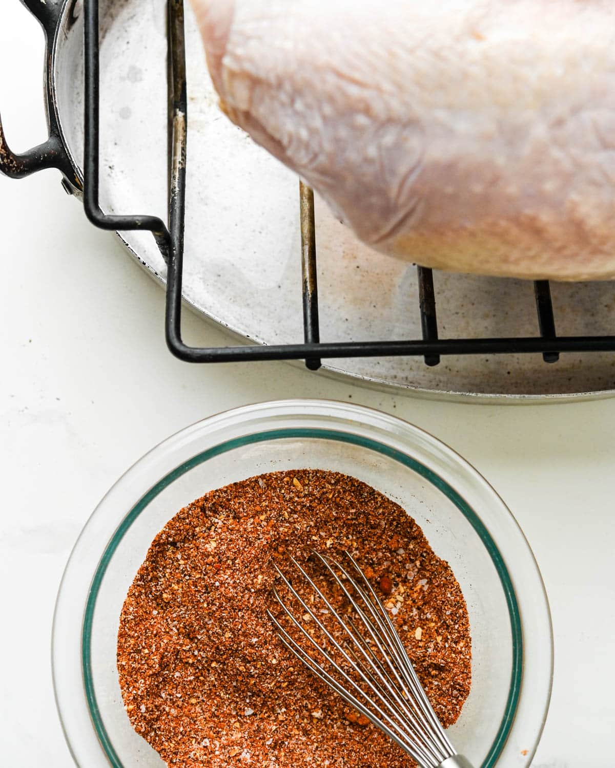 Coating the turkey breast with dry rub.
