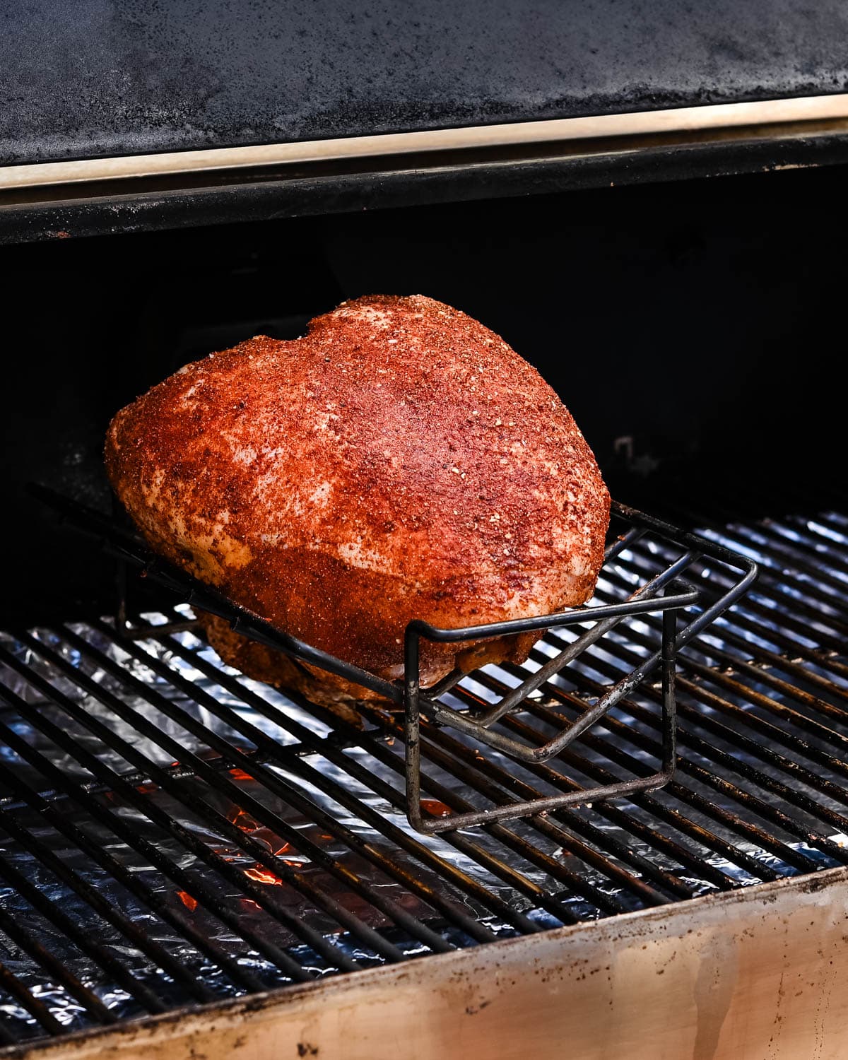 Fitting the turkey breast on a rack to smoke it.