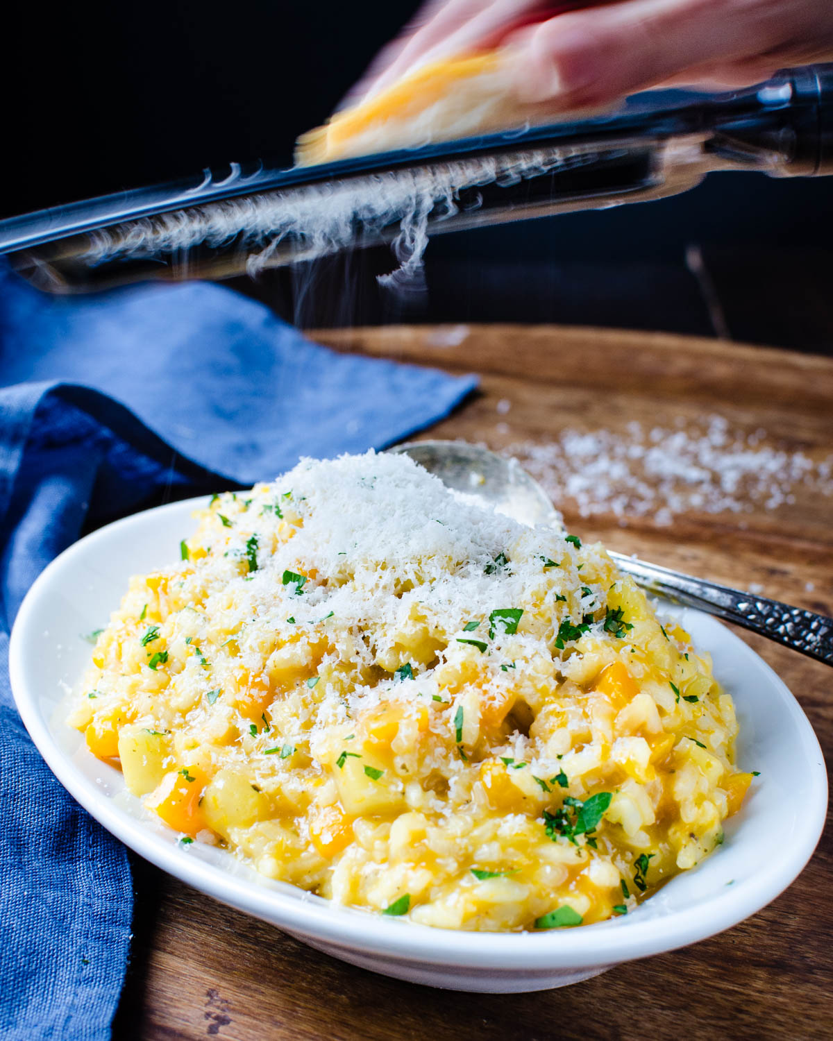 Adding extra parmesan cheese to the squash risotto platter.