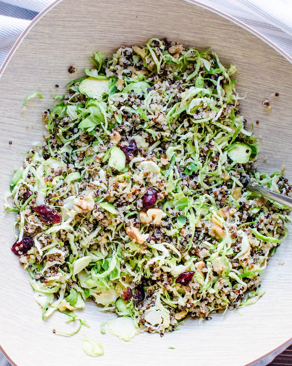 Toss the quinoa and brussels sprouts salad with dried cranberries. 