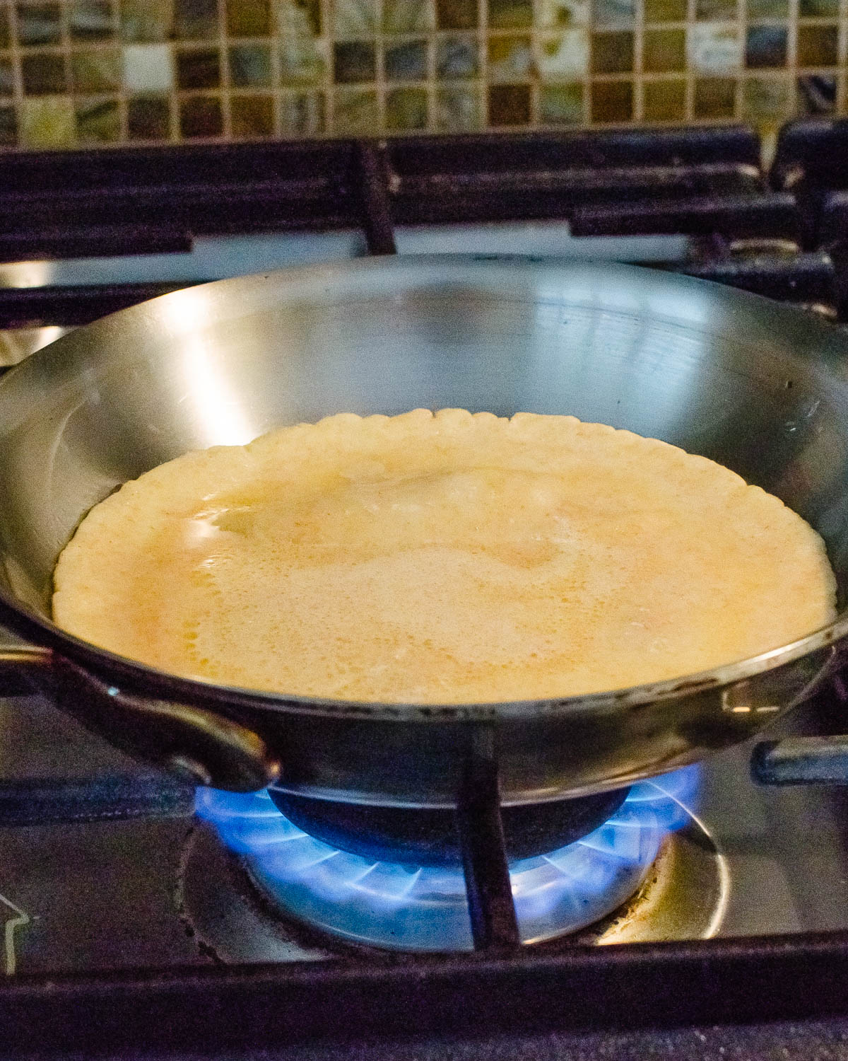 Cooking crepes in a skillet.