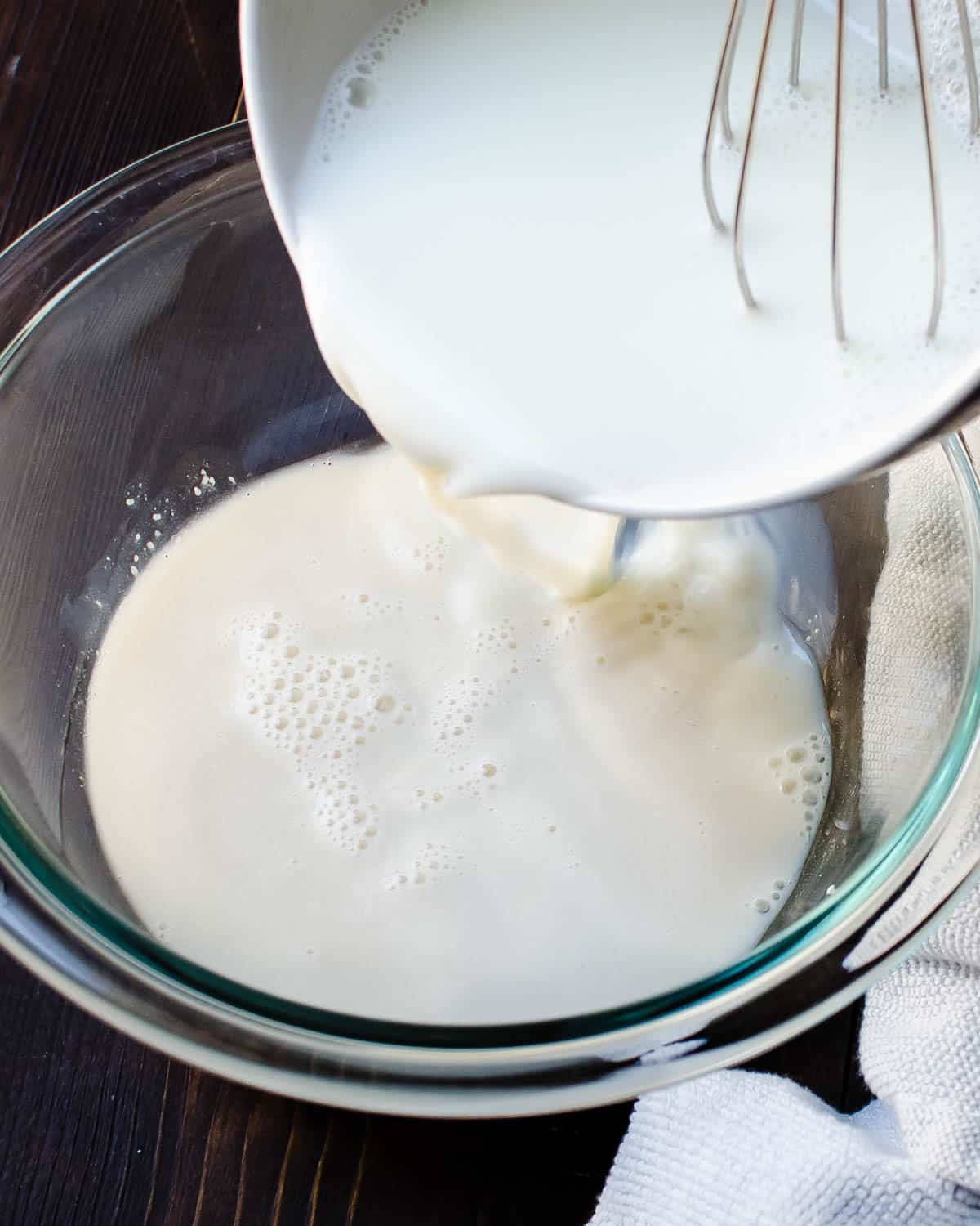 Adding milk to the yeast.