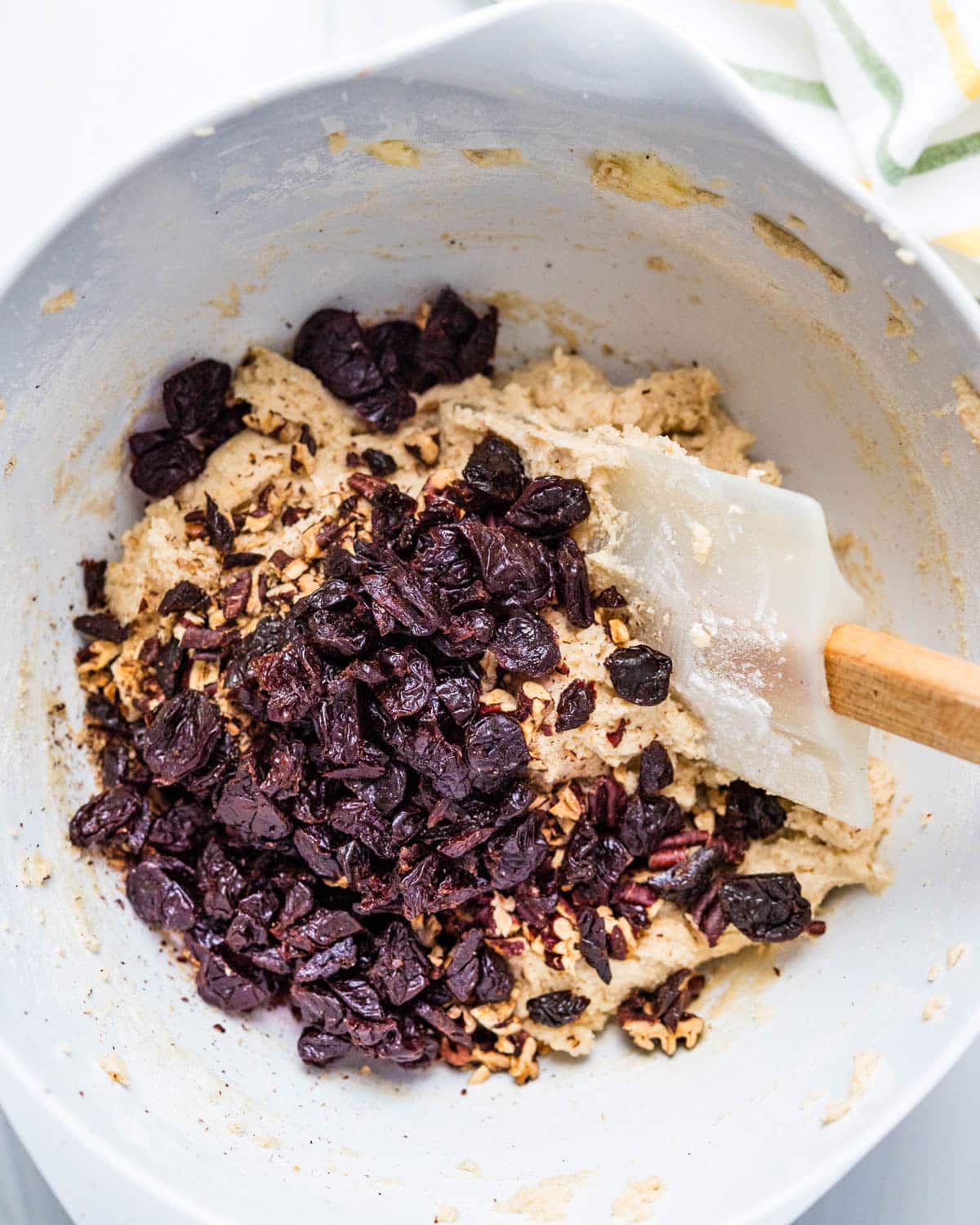 I am stirring dried cherries and toasted pecans into the cookie dough.