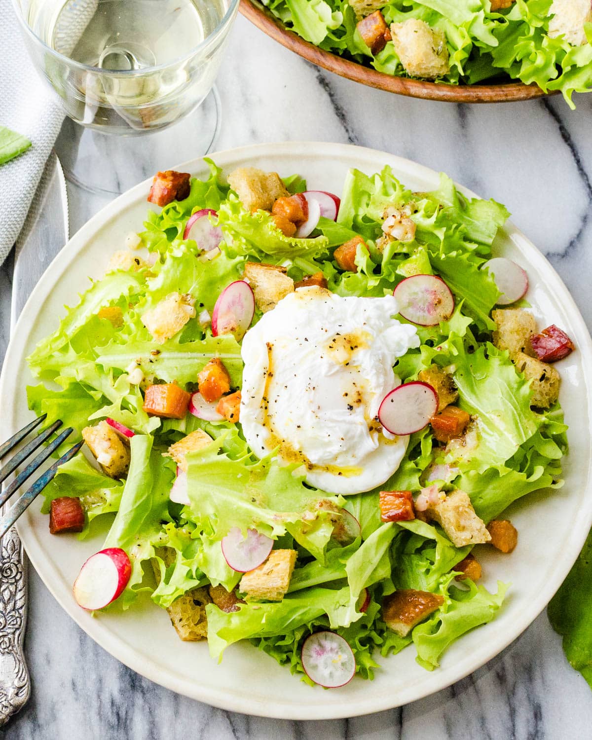 Frisee lardons salad with poached eggs and croutons.