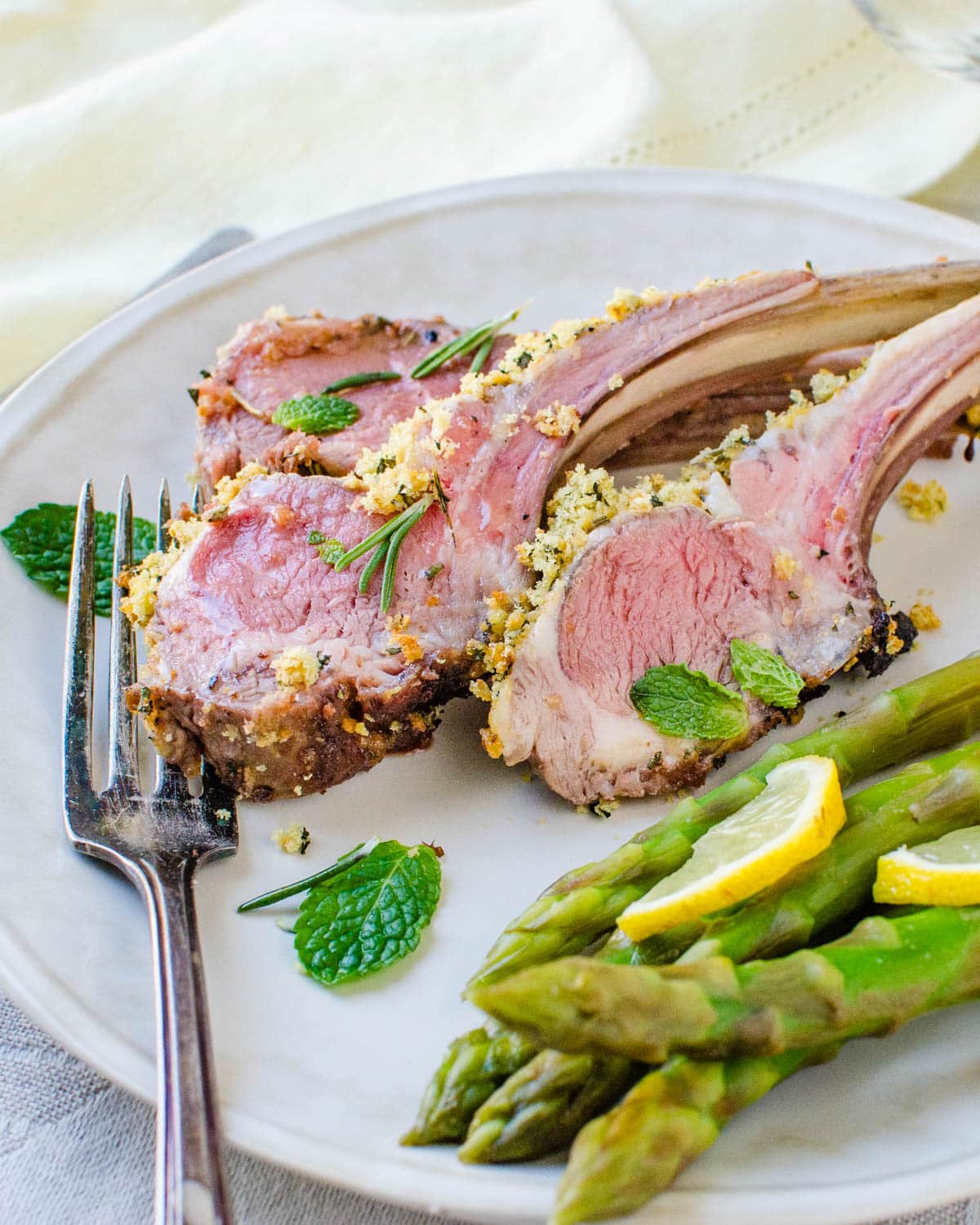 Serving the rack of lamb with asparagus.