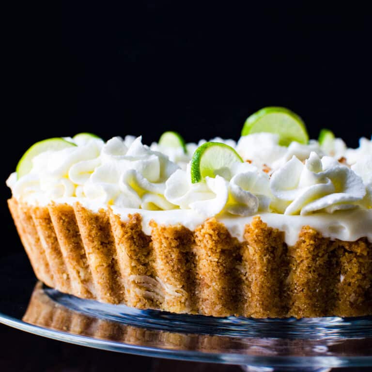 Key lime mousse tart on a cake plate.