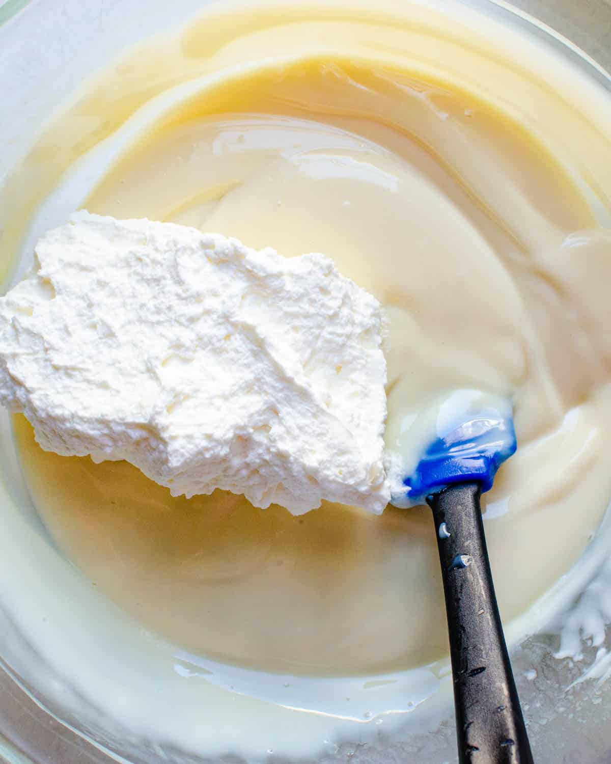 Fold the stabilized whipped cream into the custard.