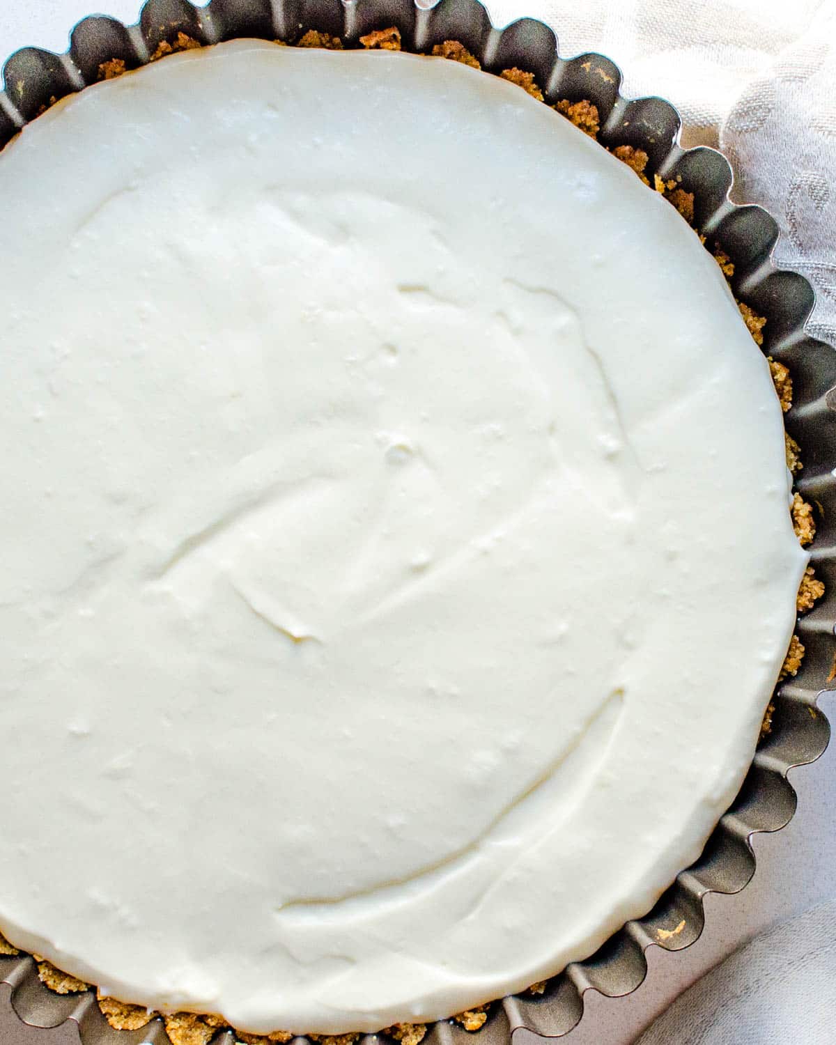 Fill the baked crust with key lime mousse.