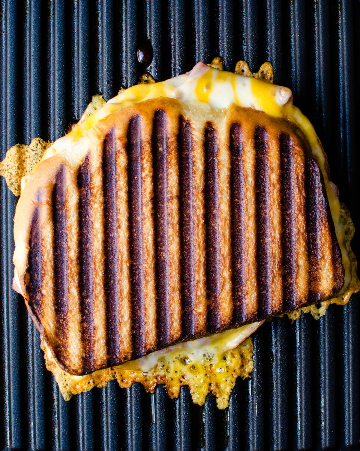 The ham and cheese sandwich on a panini press.