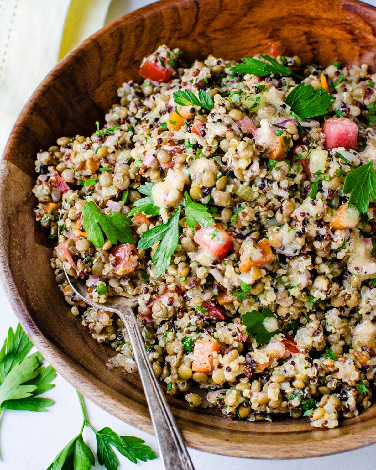 Homemade lentil salad with quinoa, fresh vegetables and herbs.