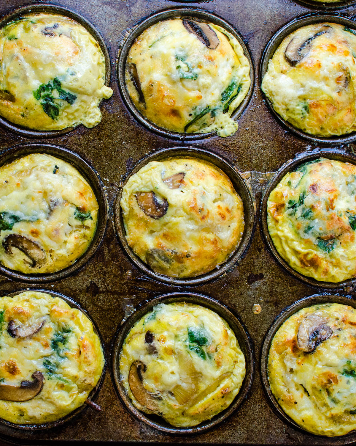 Baked Mushroom Spinach Frittatas in a muffin tin.