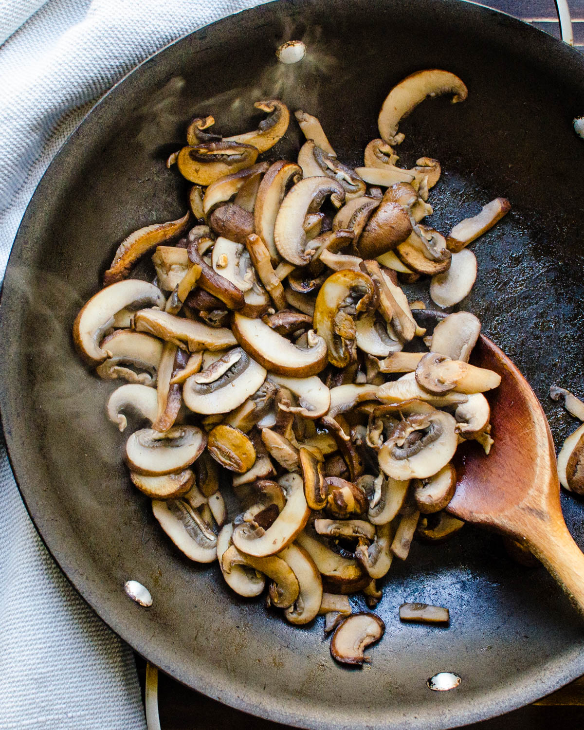Cooking mushrooms in a skillet.