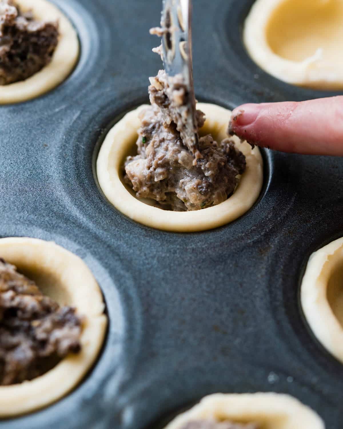 I am adding the mushroom filling to the hors d'oeuvres pastry.