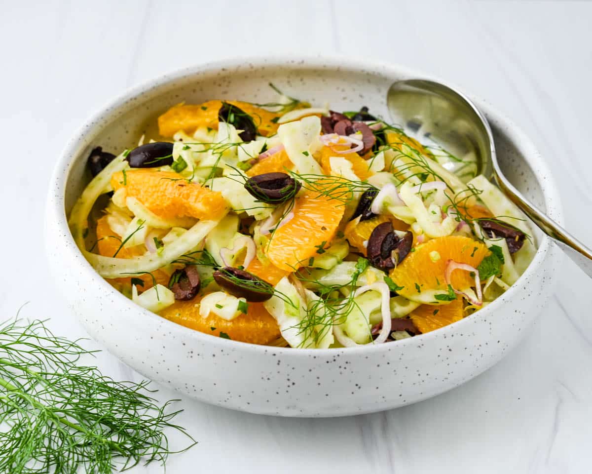 A bowl of citrus salad with fennel fronds to garnish.