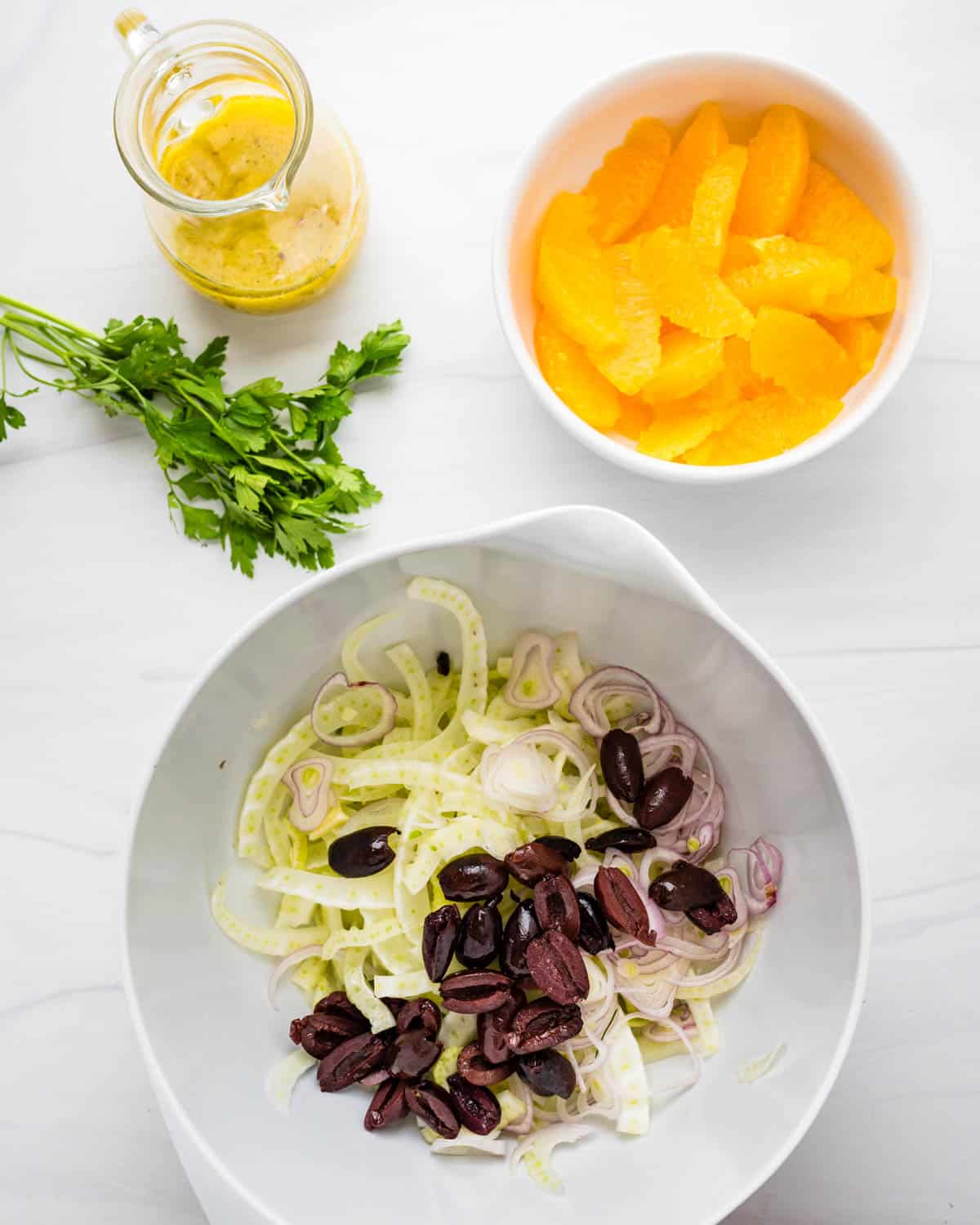 Assembling the citrus salad in a bowl.