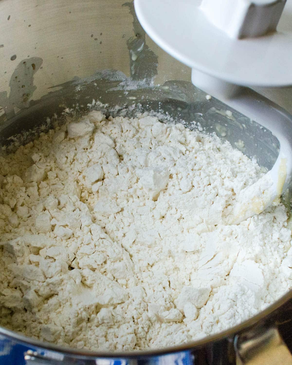 Mixing the flour into the dough with a stand mixer.