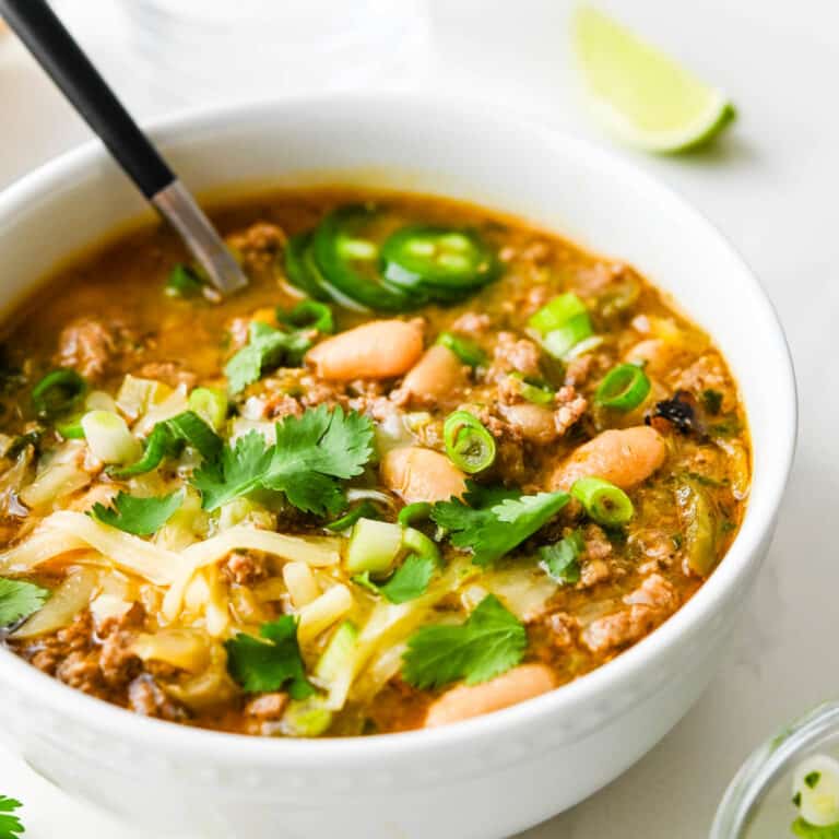 Turkey Chili with White Beans Recipe in a white bowl with garnishes.
