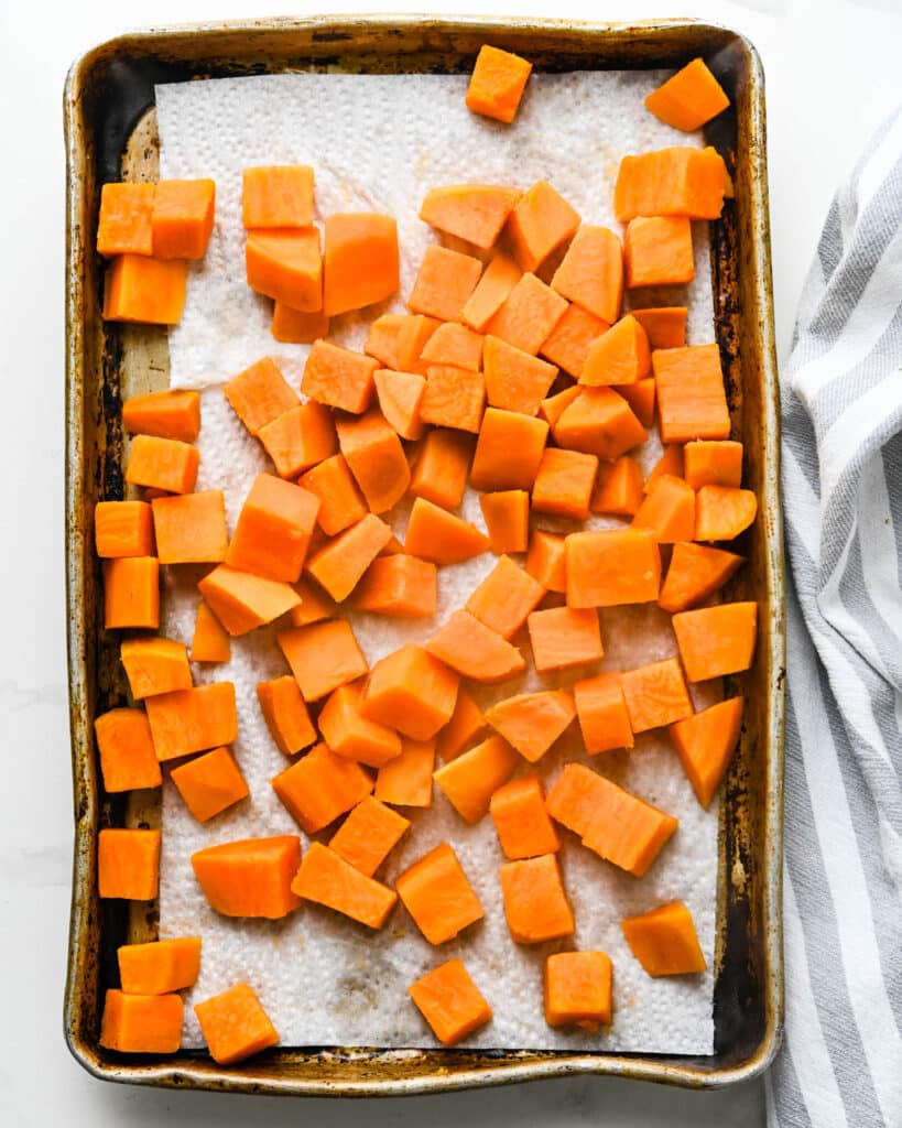 Spread the sweet potatoes on a paper towel lined sheet pan to cool and air dry so there's no excess moisture. 