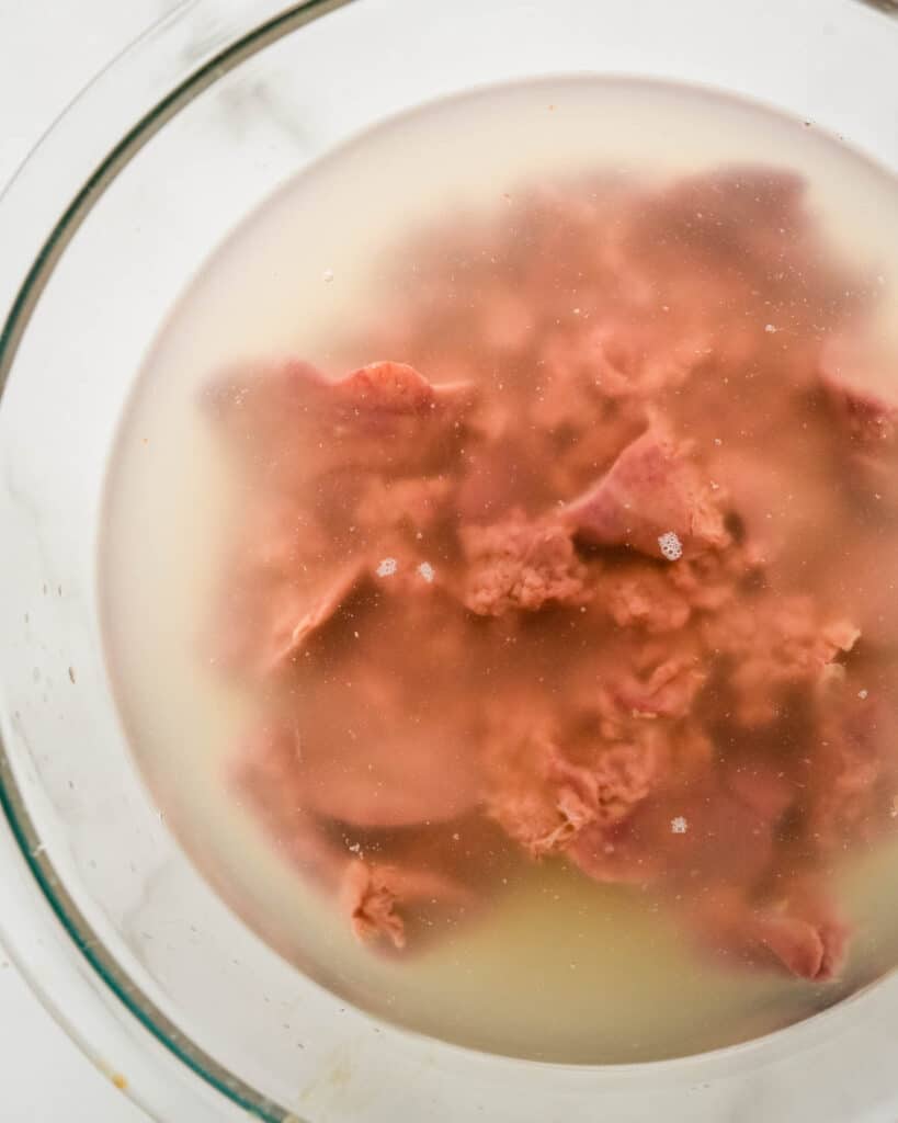 Brining chicken livers in a salt and water solution.