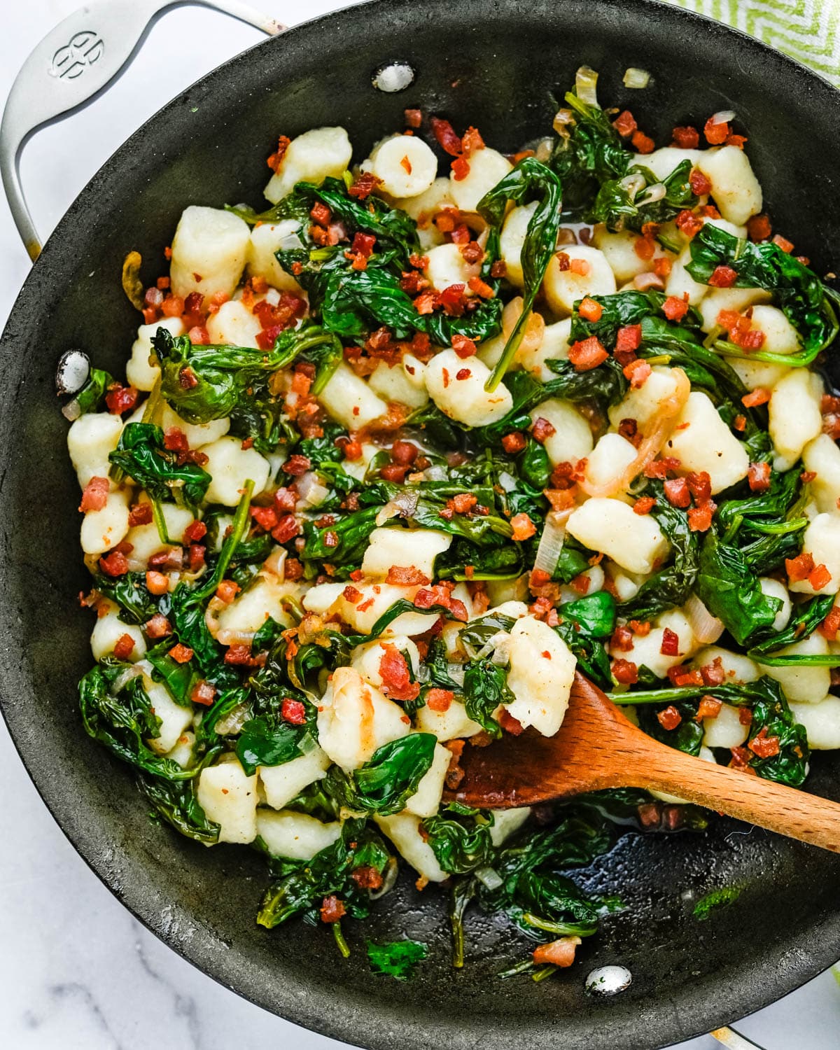 Pan-sauteed Italian gnocchi with pancetta and spinach.