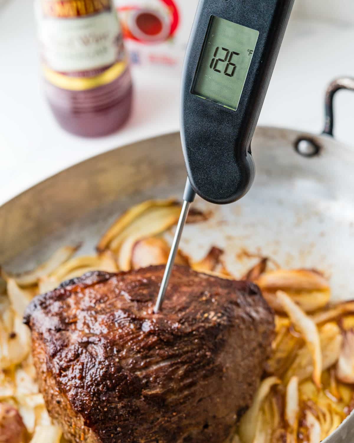 Checking the internal temperature of the beef eye of round roast.