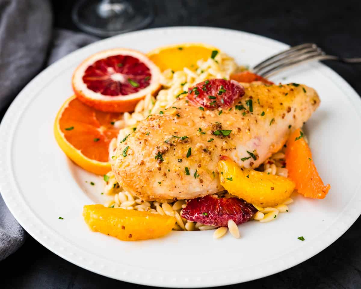 Serving the Dijon citrus chicken over a bed of orzo pasta.