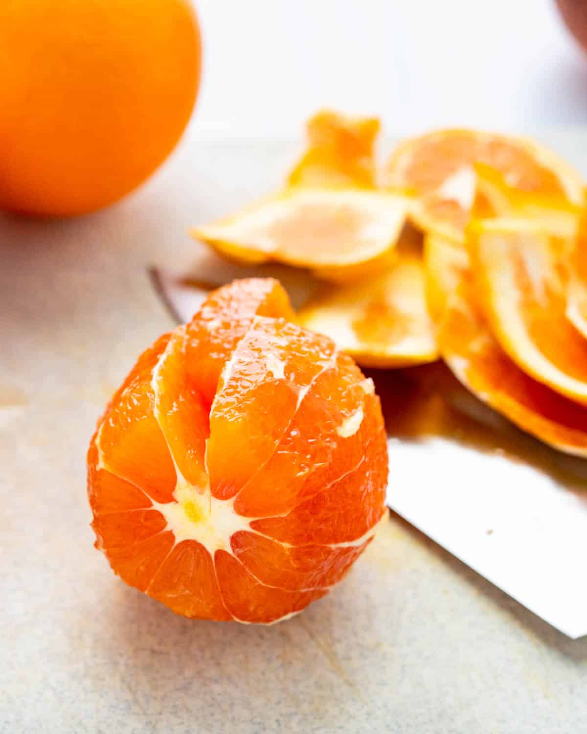 Cutting individual segments from the oranges.