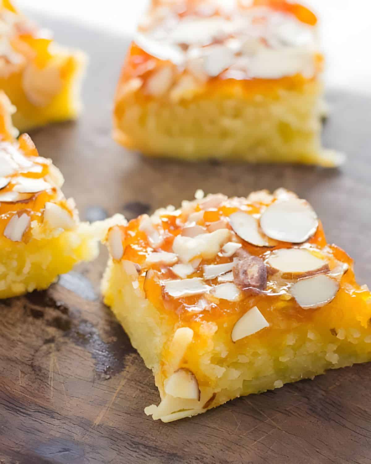 Serving apricot bars on a wooden board.