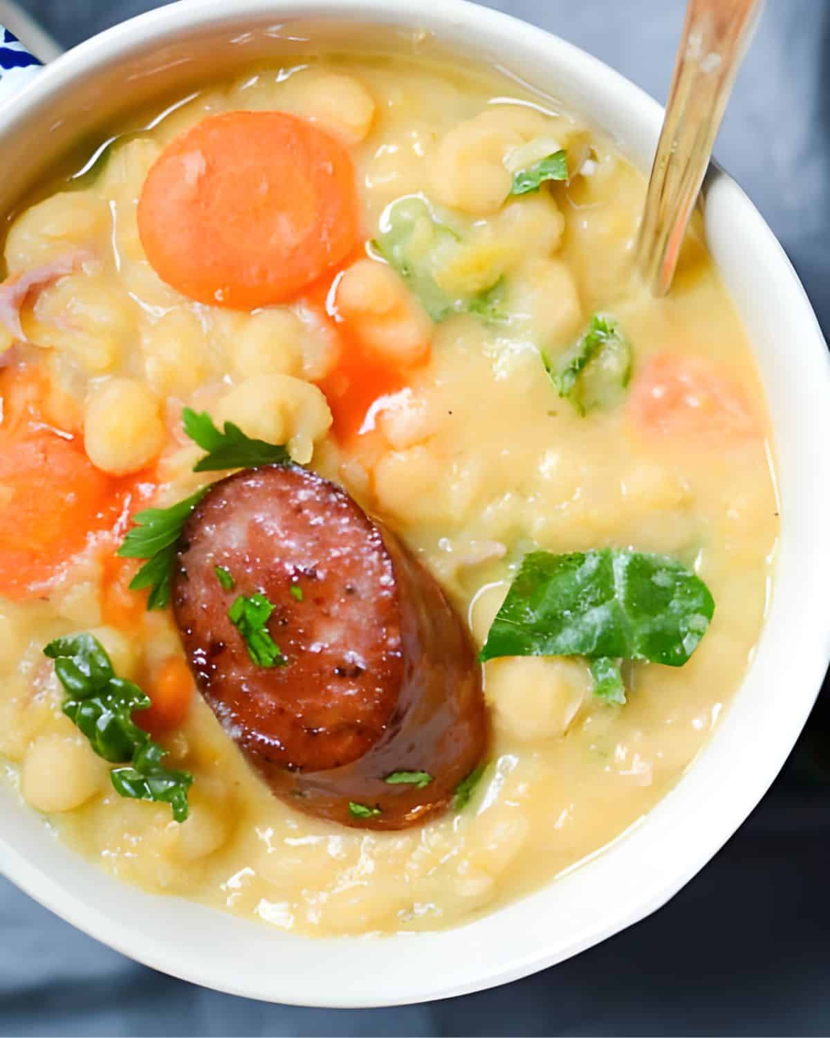 Serving yellow pea soup with smoked sausage and hot sauce.