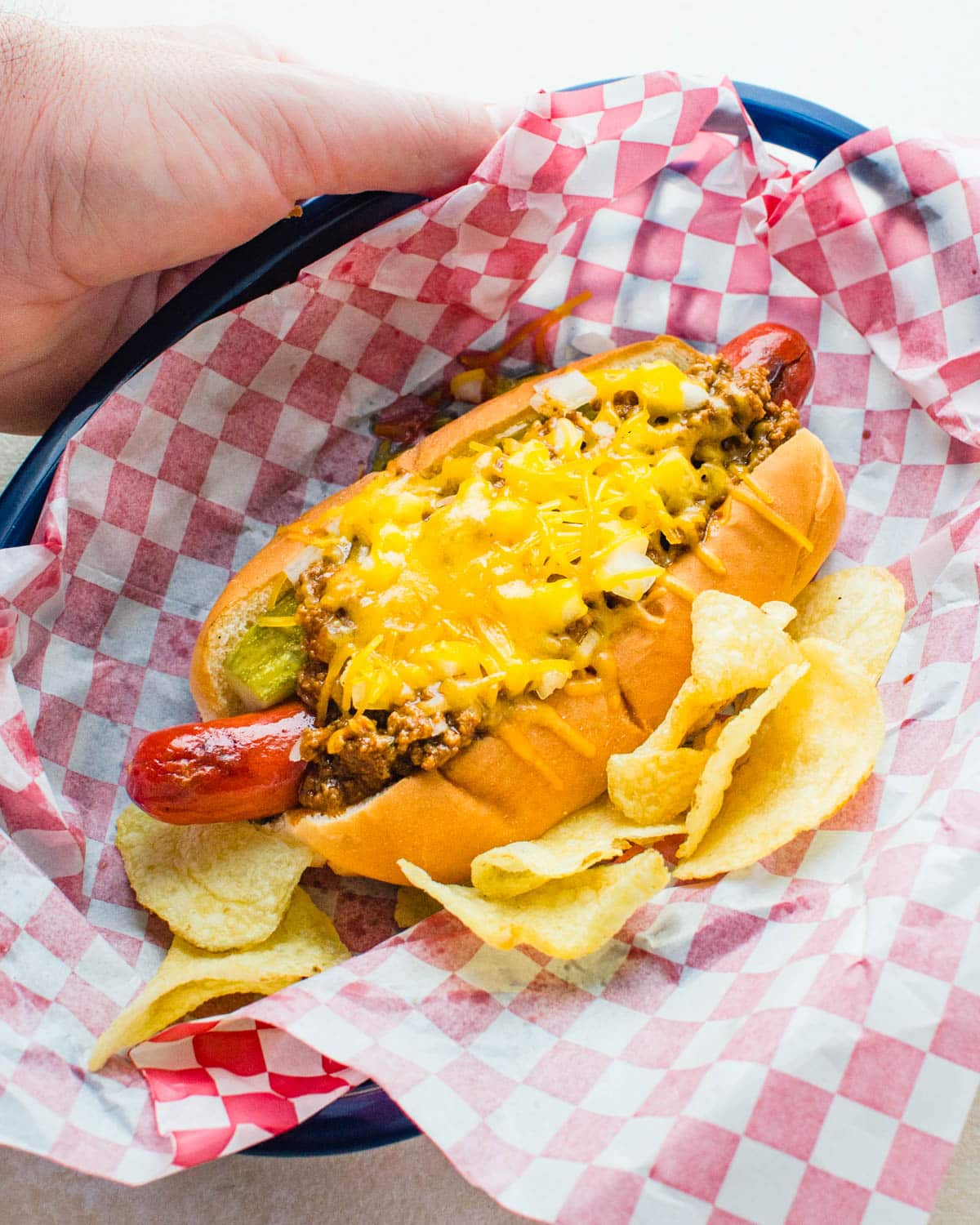 The chili dog in a paper lined basket.